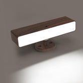 Modern wall-mounted light fixture with wooden finish on a gray background